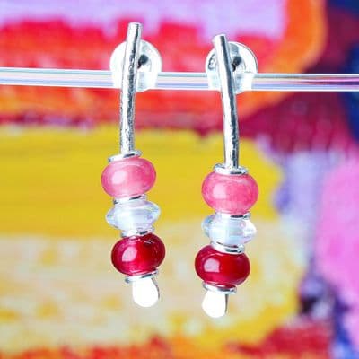 Handmade red and pink arc earrings featuring chalcedony and rock crystal. S.