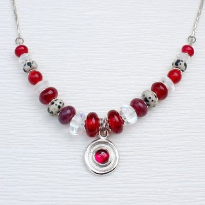 Handmade red gemstone necklace featuring corundum, chalcedony and rock crystal