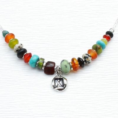 Handmade silver pendant necklace featuring numerous gemstones