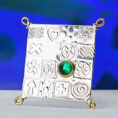 Handmade square sterling silver brooch featuring a green spinel gemstone.
