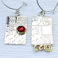 Handmade sterling silver asymmetrical earrings, featuring a blue Opal gemstone, embossed silver.  .