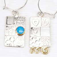 Handmade sterling silver asymmetrical earrings, featuring a blue Opal gemstone, embossed silver.  .