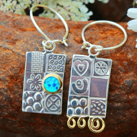 Handmade sterling silver asymmetrical earrings, featuring a blue Opal gemstone, embossed silver.  .