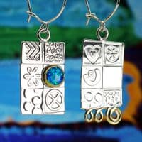 Handmade sterling silver asymmetrical earrings, featuring a blue Opal gemstone, embossed silver.  .