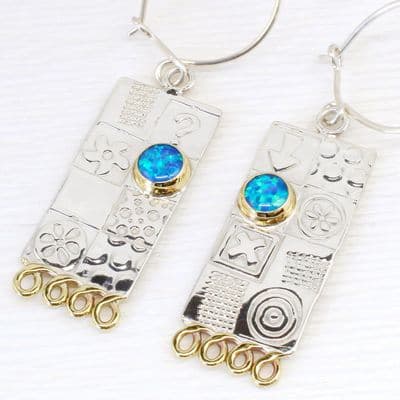 Handmade sterling silver earrings featuring blue opal gemstones. Matching lrg.