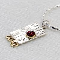 Handmade sterling silver pendant with a garnet gemstone and silver chain.  M. Gemstone choice.