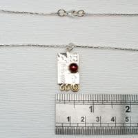 Handmade sterling silver pendant with a garnet gemstone and silver chain.  M. Gemstone choice.