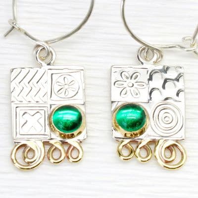 Matching small silver earrings featuring green spinel gemstones.