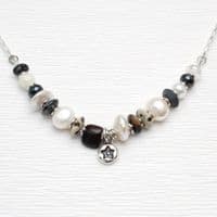 Star pearl necklace featuring freshwater pearls and a hand-carved wooden bead