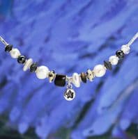 Star pearl necklace featuring freshwater pearls and a hand-carved wooden bead