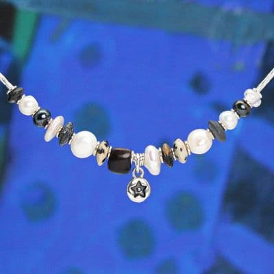 Star pearl necklace featuring freshwater pearls and a hand-carved wooden bead