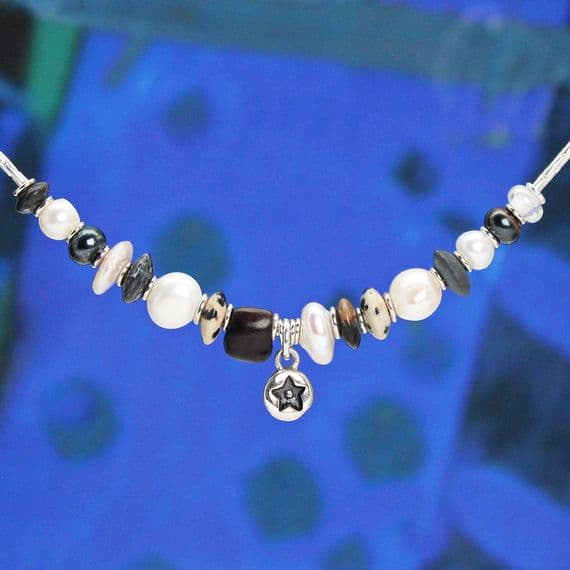 Star pearl necklace featuring freshwater pearls and a hand-carved wooden bead