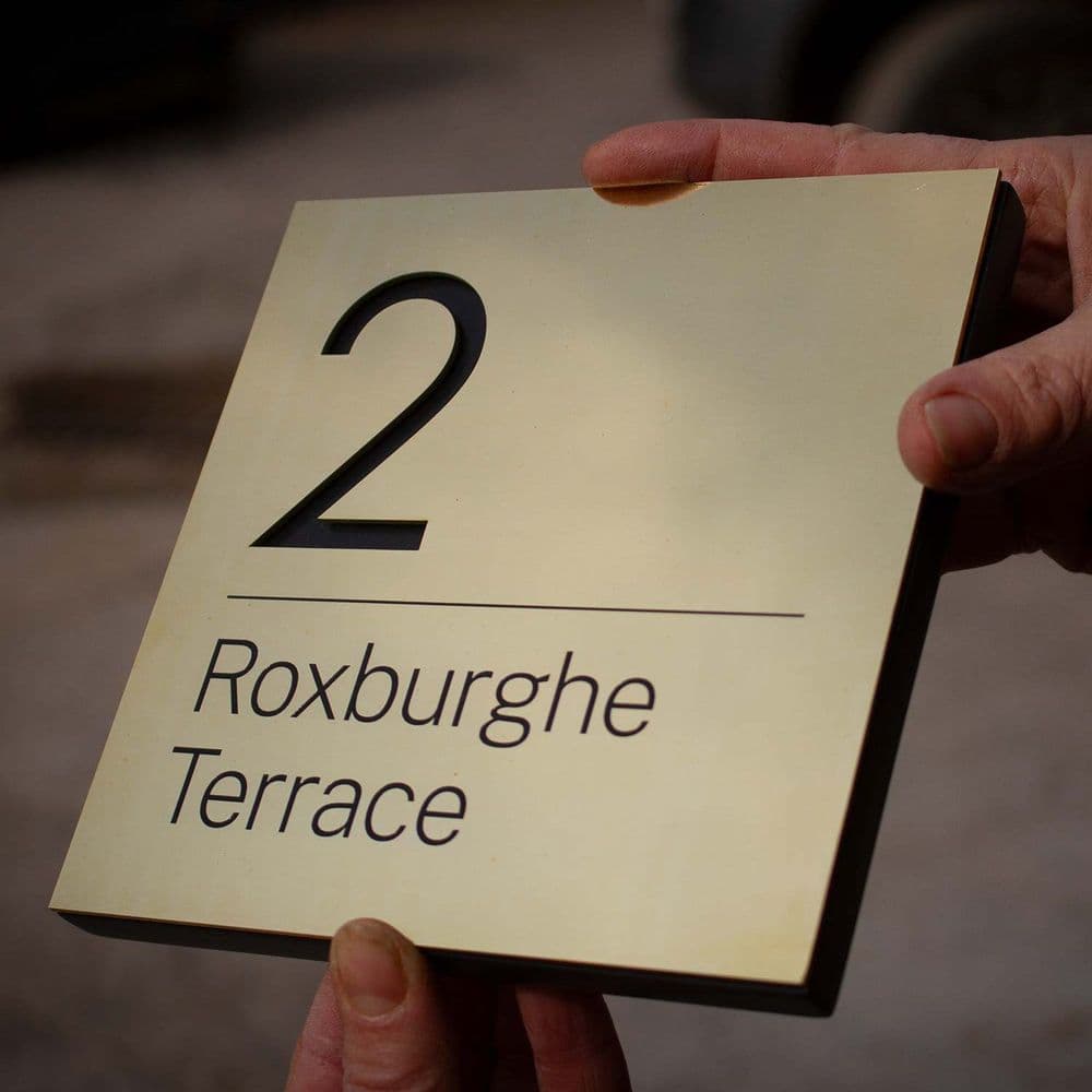 Brass Address Sign with Cut Out Number on Black Corian same size backing board