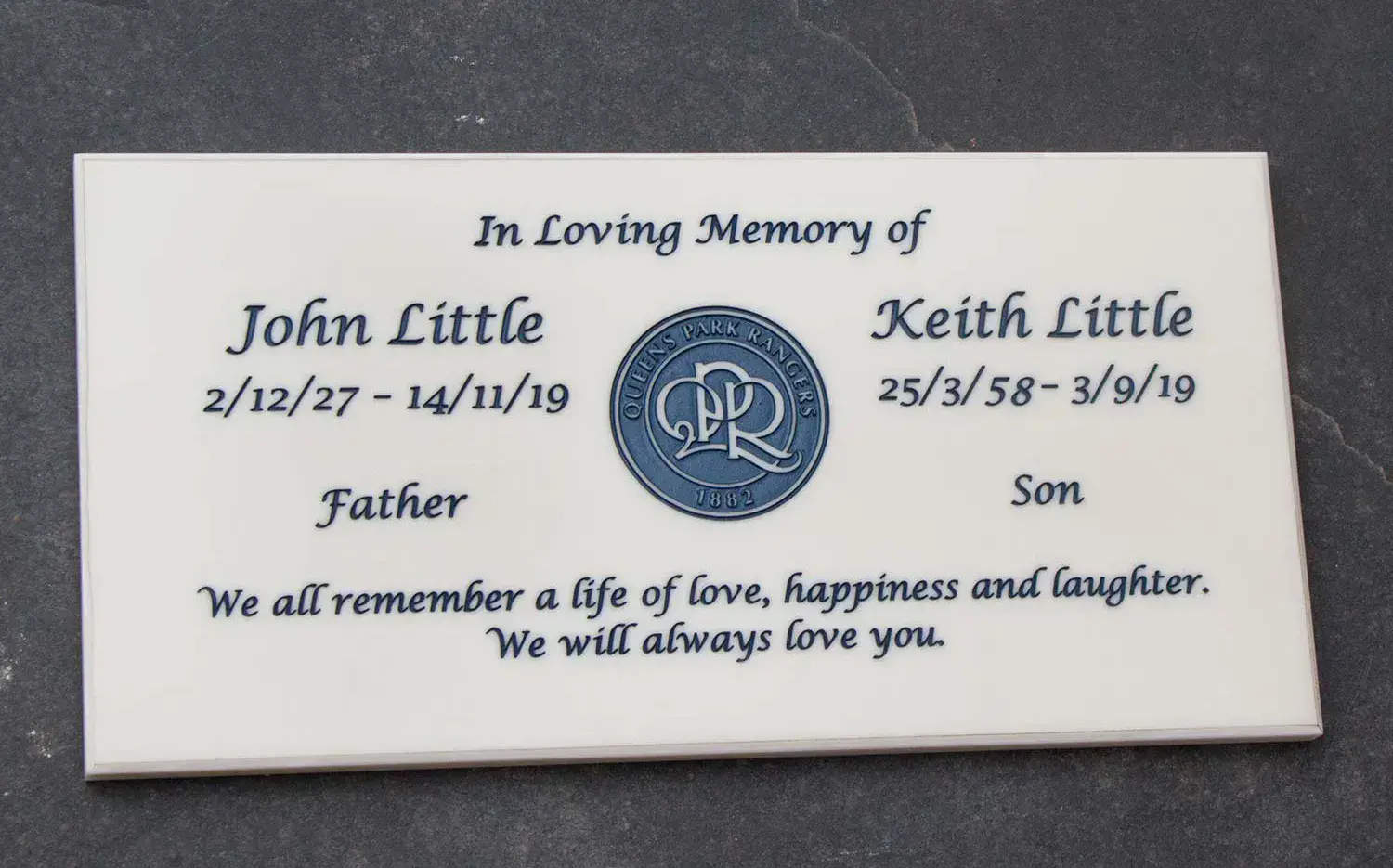 Engraved corian plaque with a logo.