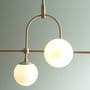 Bourges 5 Light Linear Pendant in a Matt Antique Brass Finish with Matt Opal Glass Shades