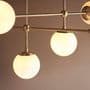 Bourges 6 Light Fitting in a Matt Antique Brass Finish with Matt Opal Glass Shades