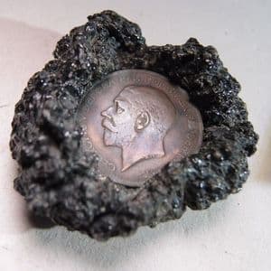 BRITISH PENNY SET IN VOLCANIC LAVA THOUGHT TO BE FROM THE 1944 ERUPTION OF VESUVIUS