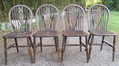 Set of Four Polished Elm Wheelback Dining Chairs - SOLD